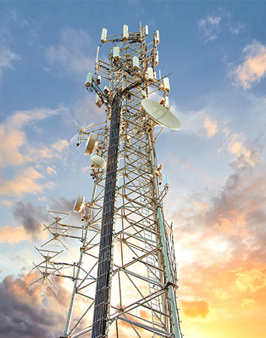 Cell Tower with partly cloudy sky behind